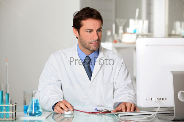 Lab technician studying test results on a computer