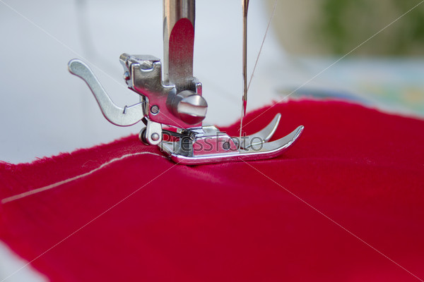 Closeup details of tailors work on a sewing machine. This is how handmade clothes are made at home.