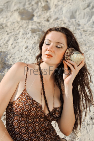 summer portrait of attractive woman listening the sound of sea
