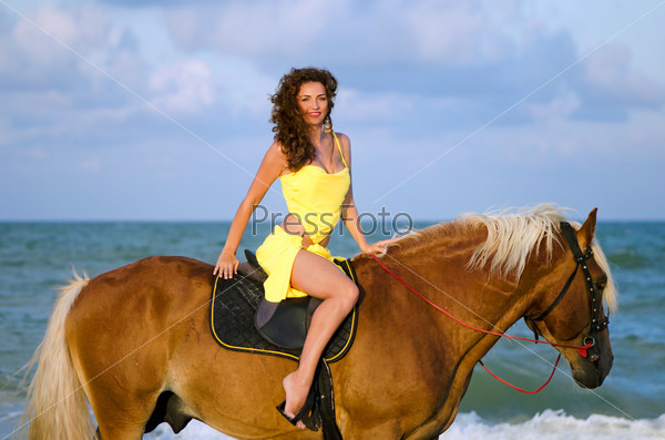 Nice young woman riding a horse