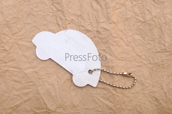 model car with silver chain on old paper background. space for your text