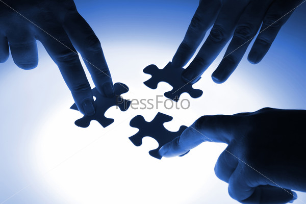 Puzzle piece coming down into its place, stock photo