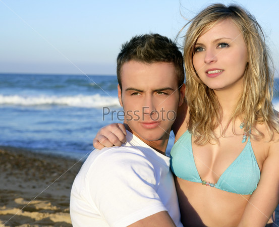 Couple hug on the blue beach, summer sunset