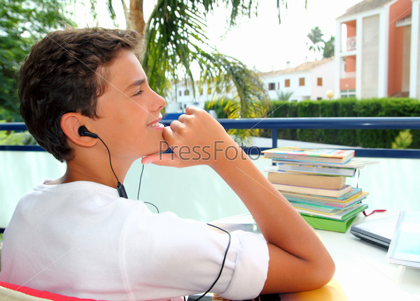 Boy teenager relaxed outdoor earphones hearing music in garden