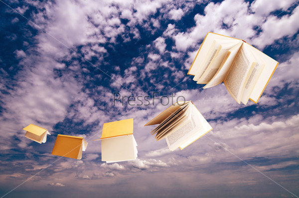 flock of books flying on blue sky background
