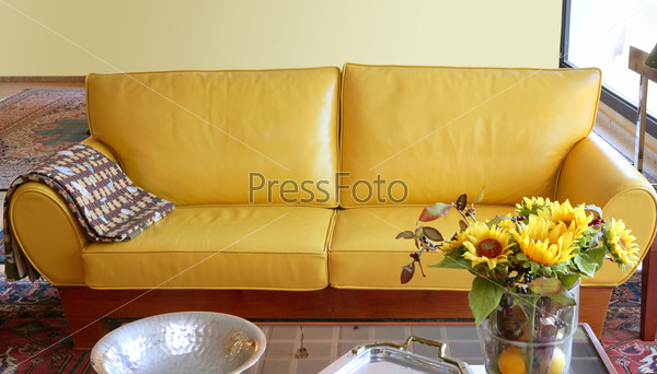 Yellow leather sofa interior sunflower bouquet