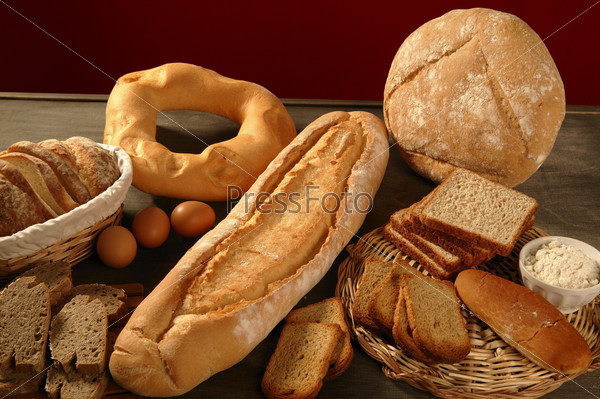 Bread still live over dark wood background, varied shapes