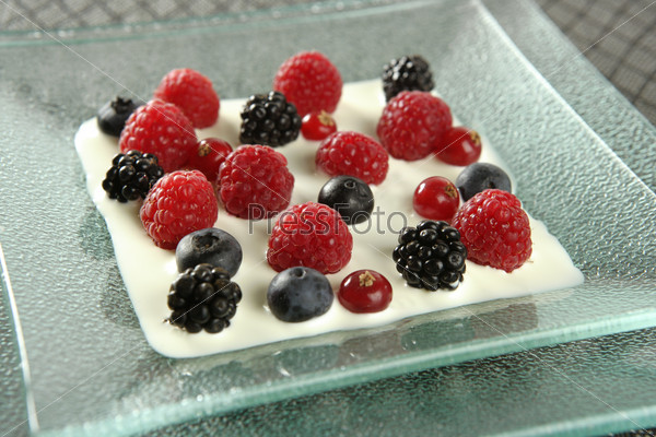 Dessert of mixed and varied berries and cream
