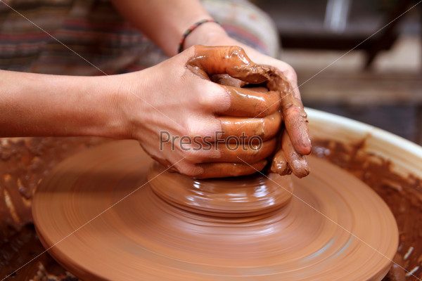 clay potter hands closeup working on wheel handcrafts