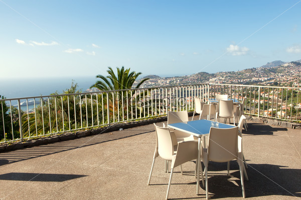 Empty cafe tables high over Funchal city and Atlantic ocean, Madeira, Portugal