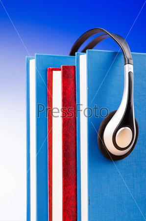 Concept of audio books with earphones on white, stock photo