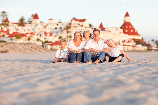 Happy Caucasian Family in Front of Hotel Del Coronado, U.S.A. on a Sunny Afternoon.