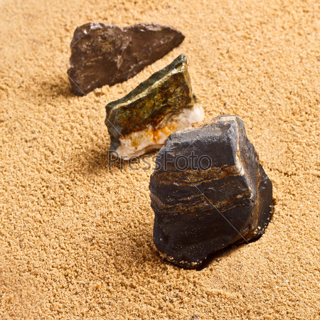 three stones in the sand texture
