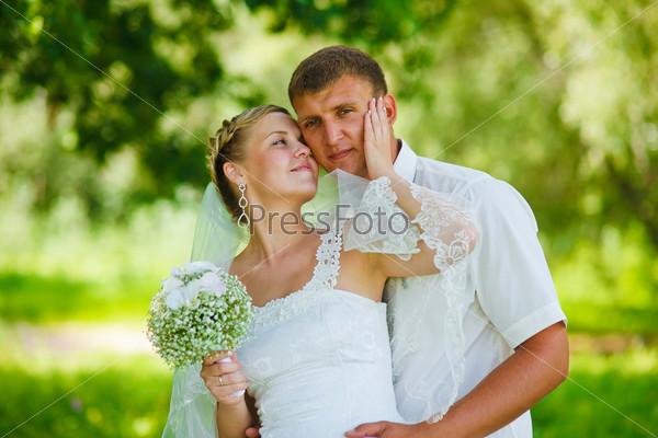 couple newlyweds wedding are in green summer forest, bride and groom large portrait