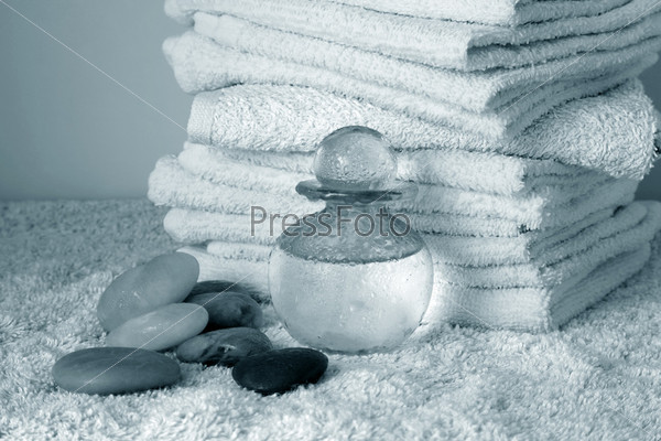 Bottle with massage oil on a background of towel, stock photo