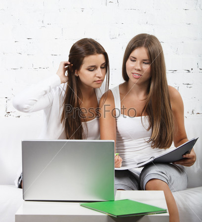 Casual dressed high school student girl study using laptop