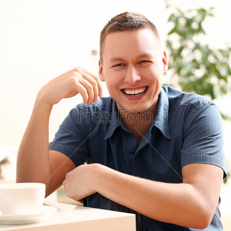 Portrait of young and happy smiling guy at home