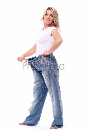 Happy mid aged woman in big pants after weight losing