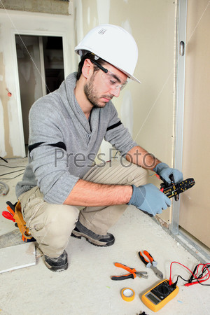 Electrical engineer snipping wire
