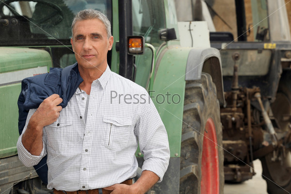 farmer posing in front of his tractor