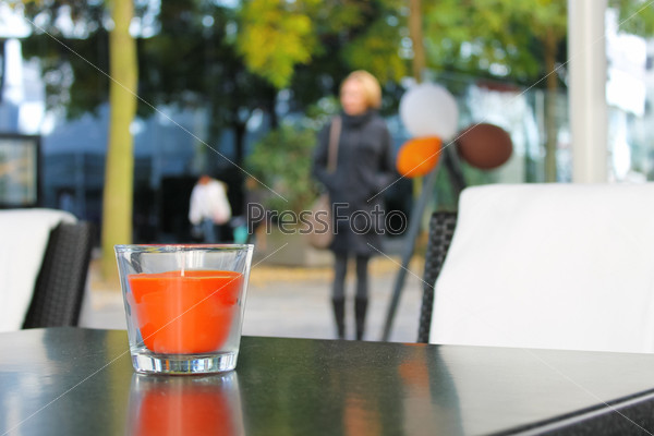 The candle on the table in the autumn cafe, stock photo