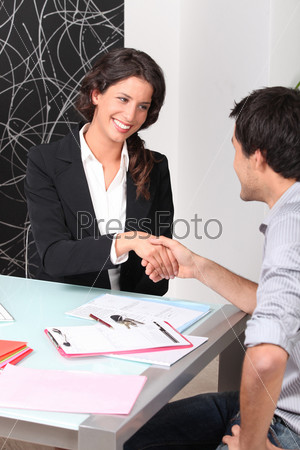 Cheerful woman and man handshaking