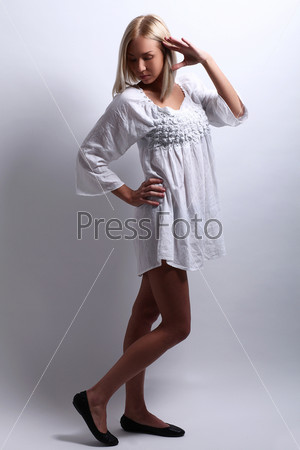 Portrait of shy beautiful blonde dressed in nightgown