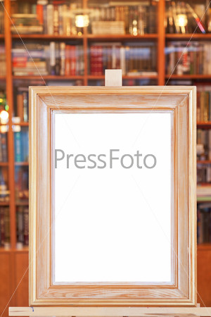White canvas of wide picture frame on easel in library