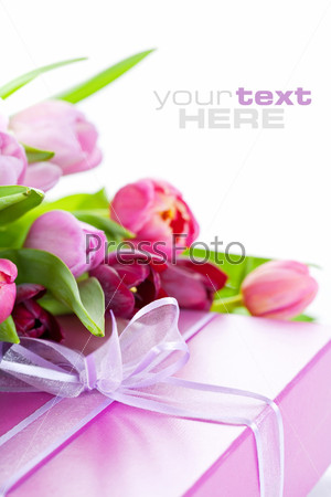 Pink tulips and gift box on a white background. With sample text.