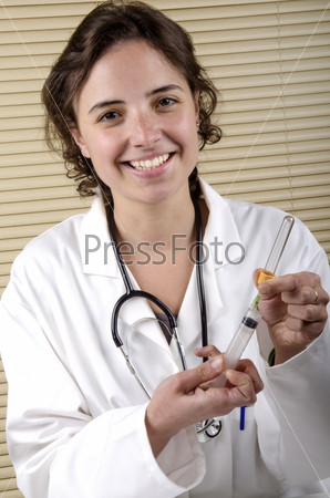 medical staff member with holding a syringe and empty blood container