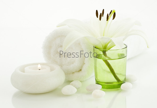 Spa concept (flower, towel, candle and pebbles). White background