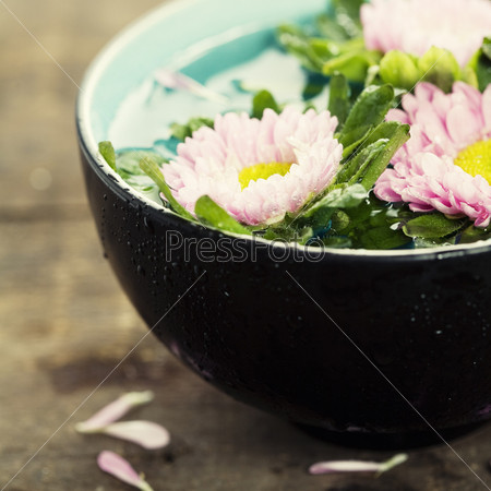 bowl of water and flowers in grunge style