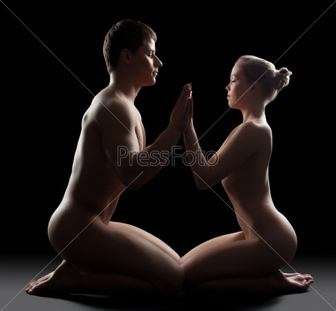 Young Couple sit in dark and take hands
