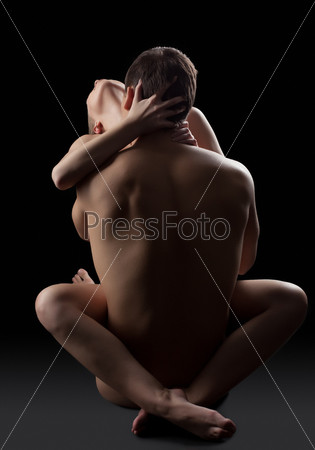 Full length portrait of young couple having sex on floor