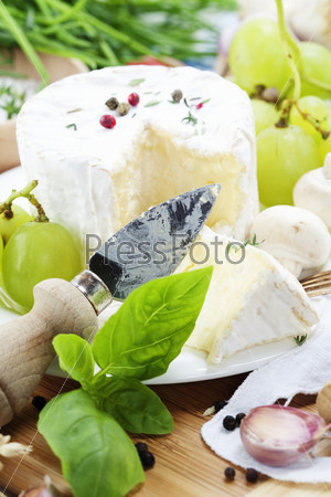 delicatessen soft cheese with grape and vegetables