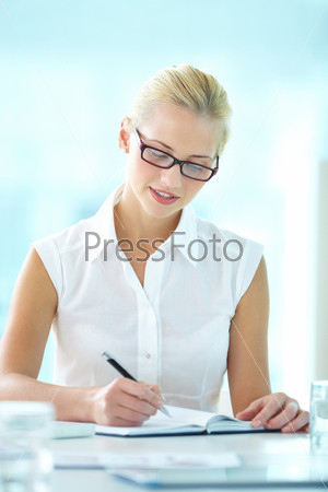 Vertical shot of a diligent secretary taking notes