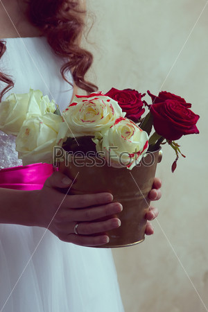 girl holding a bucket of roses