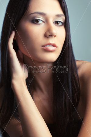 beautiful brunette woman holding  fingers on her neck