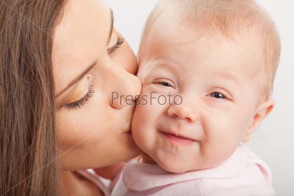 happy young mother  kissing baby girl