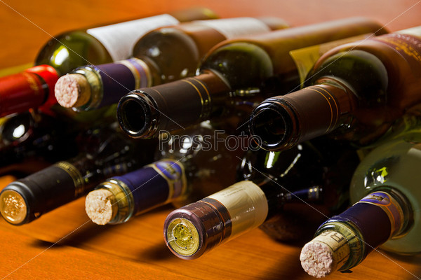 Wine bottles lying on the shelves.