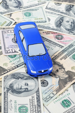 The toy car for dollar banknotes as a background