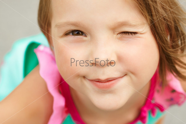 portrait of a cute girl winks closeup