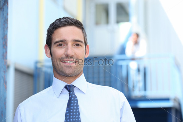 Man outside his workplace, stock photo