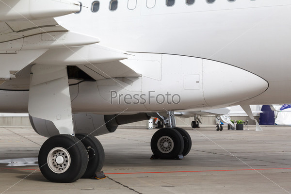 rear landing gear and jet engine passenger plane on the ground