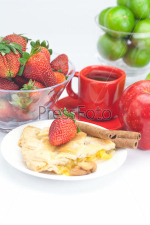 piece of apple pie, cinnamon,apple, a cup of tea, lemon, almonds and strawberries isolated on white