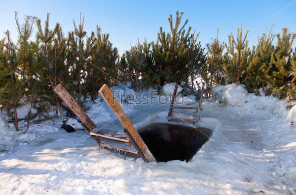 Ice hole for winter swimming at the river, stock photo