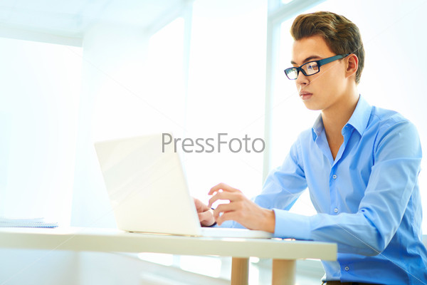 Clever business intern being busy with office work, stock photo