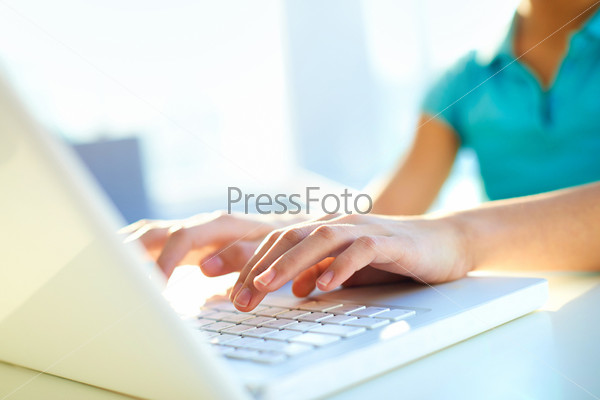 Close-up shot of a female learner typing on the laptop keyboard