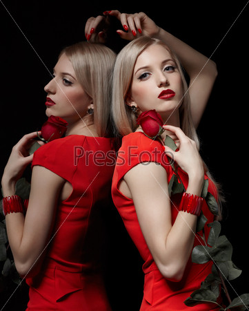 portrait of young beautiful blonde woman in red dress and bracelet with rose at mirror
