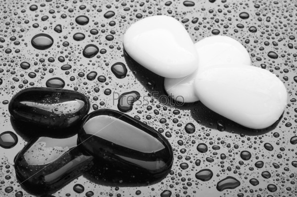 stones of black and white pebbles with water drops. abstract background, spa